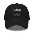 A black baseball cap with a front graphic showing a skull in a hood and the words 'SELF ISOLATING' and 'ISOLATING' in white and gray.