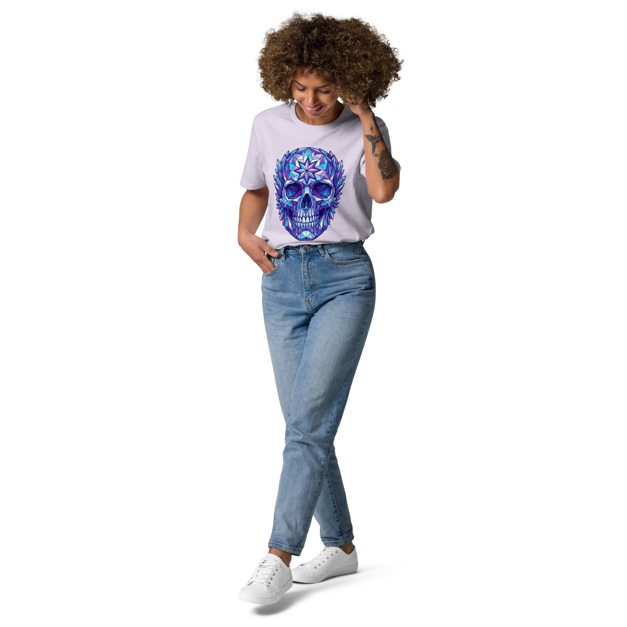 Person wearing a white t-shirt with a colorful skull design and blue jeans on a white background